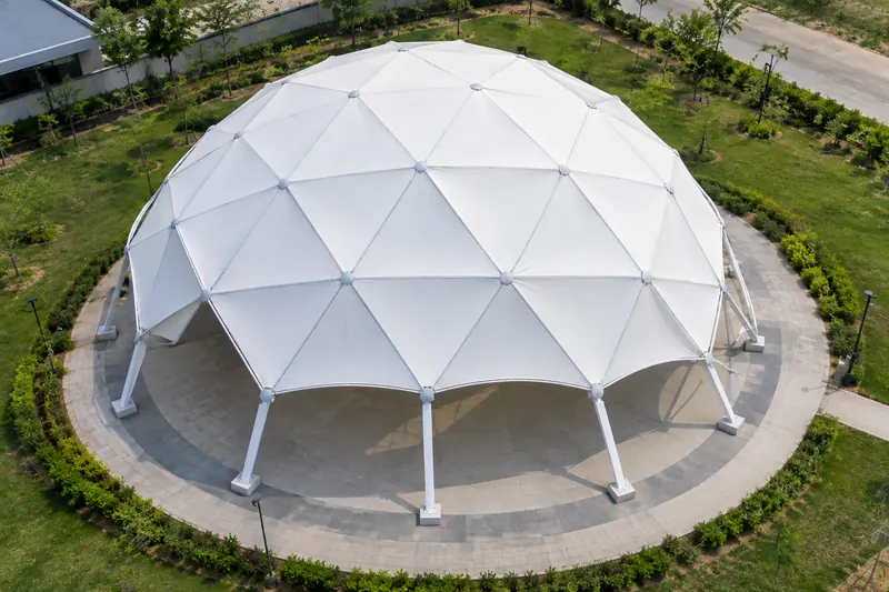 Aerial view of a geodesic tensile membrane dome over a circular plaza